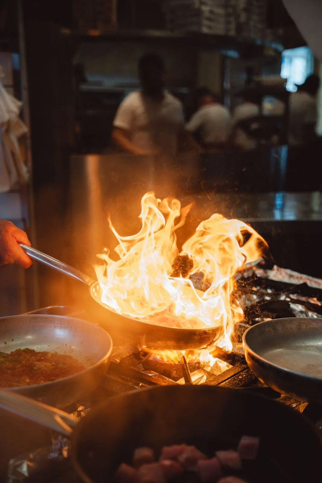 A chef plating a dish in a restaurant kitchen